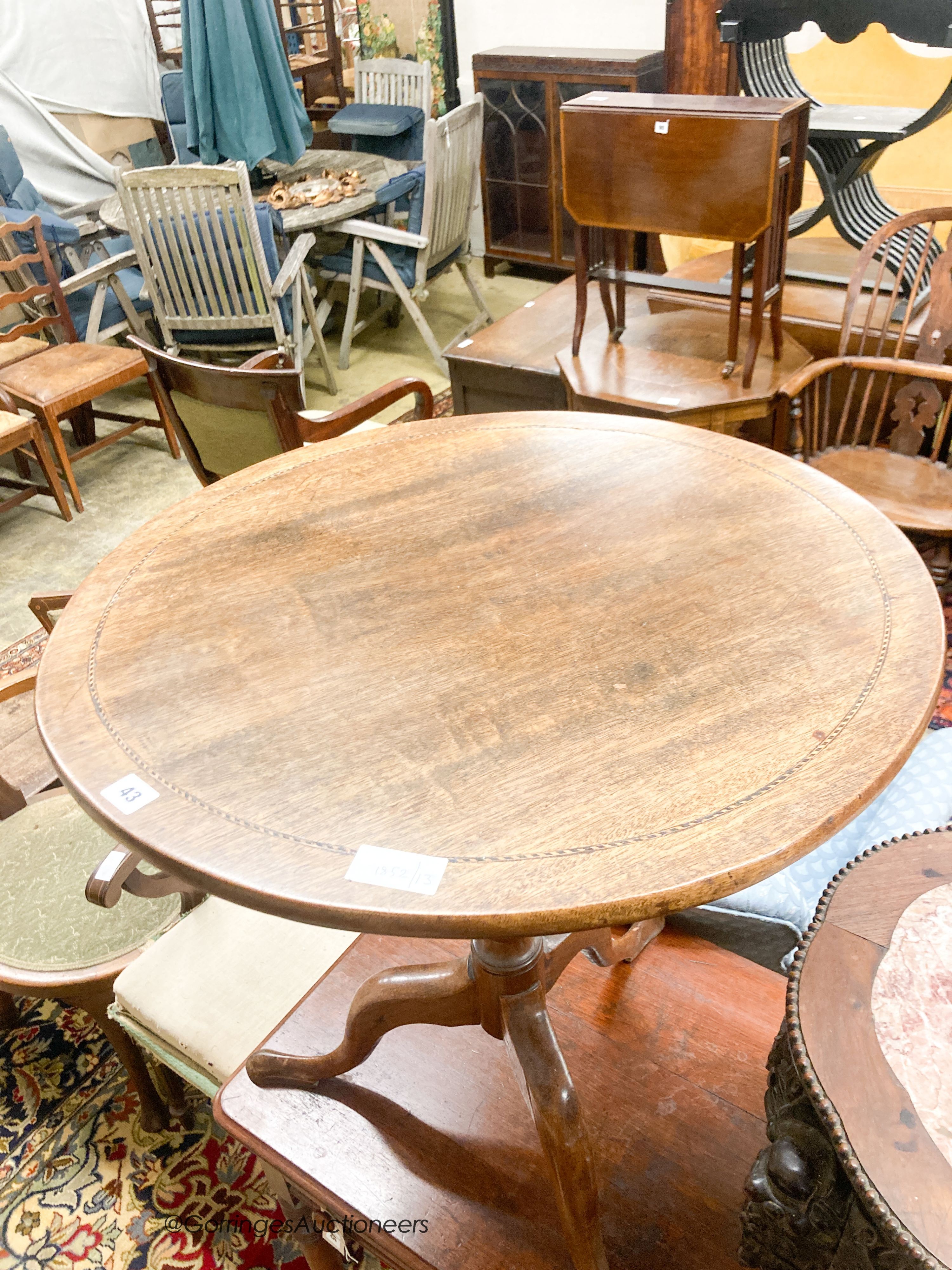 A George III circular mahogany tilt top tea table, diameter 65cm, height 70cm